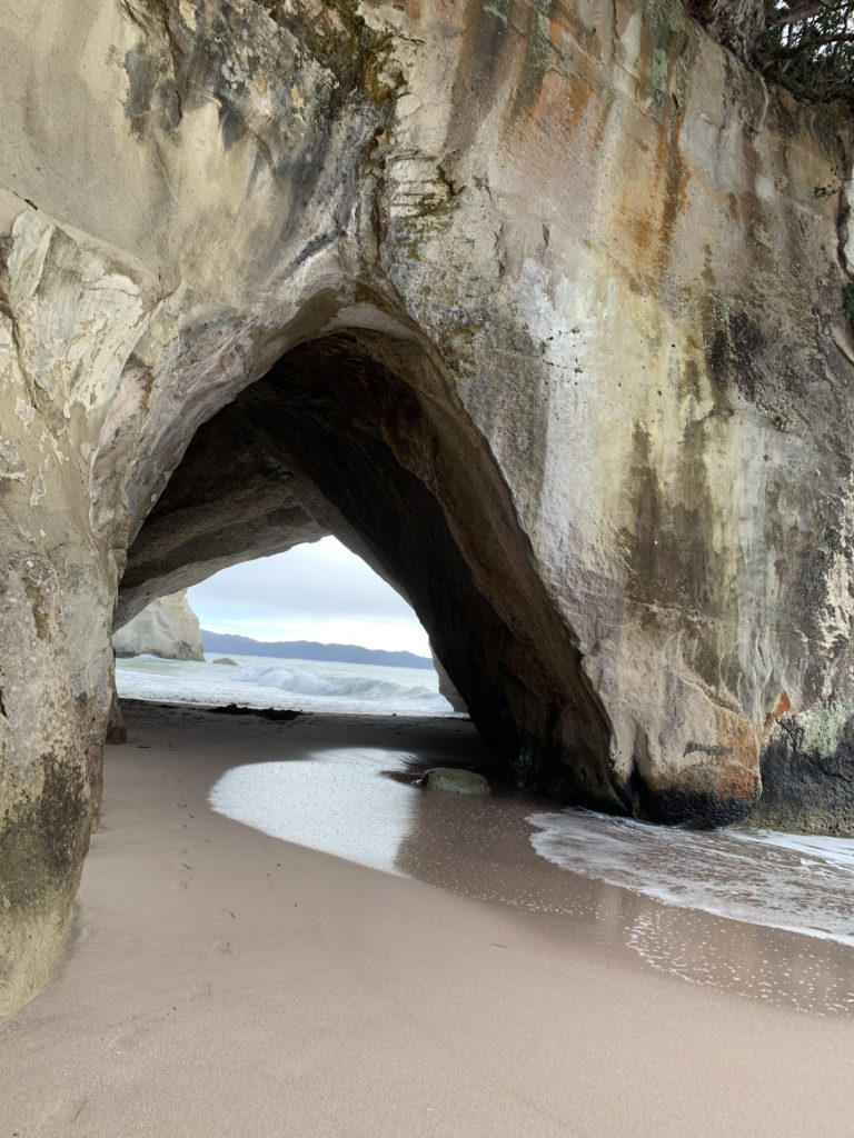 a large rock formation on a beach