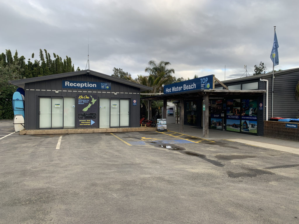 a building with a sign and a parking lot