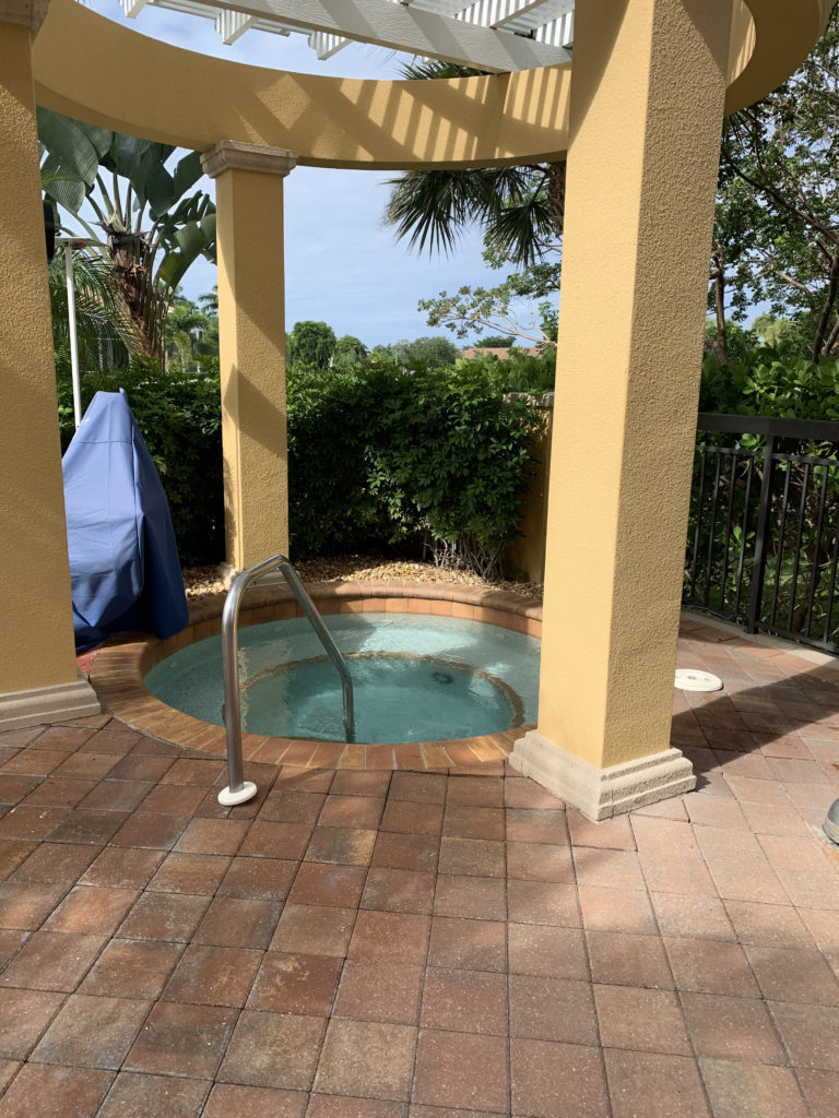 a hot tub with a metal railing