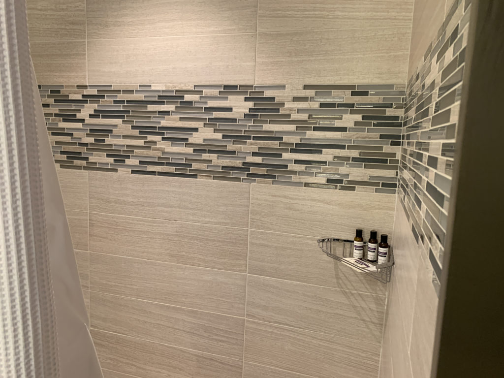 a shower with small bottles of essential oils