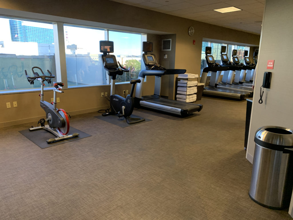 a room with exercise machines and windows