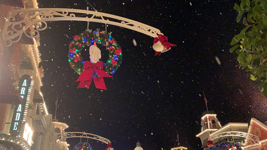 a christmas wreath and decorations on a light pole