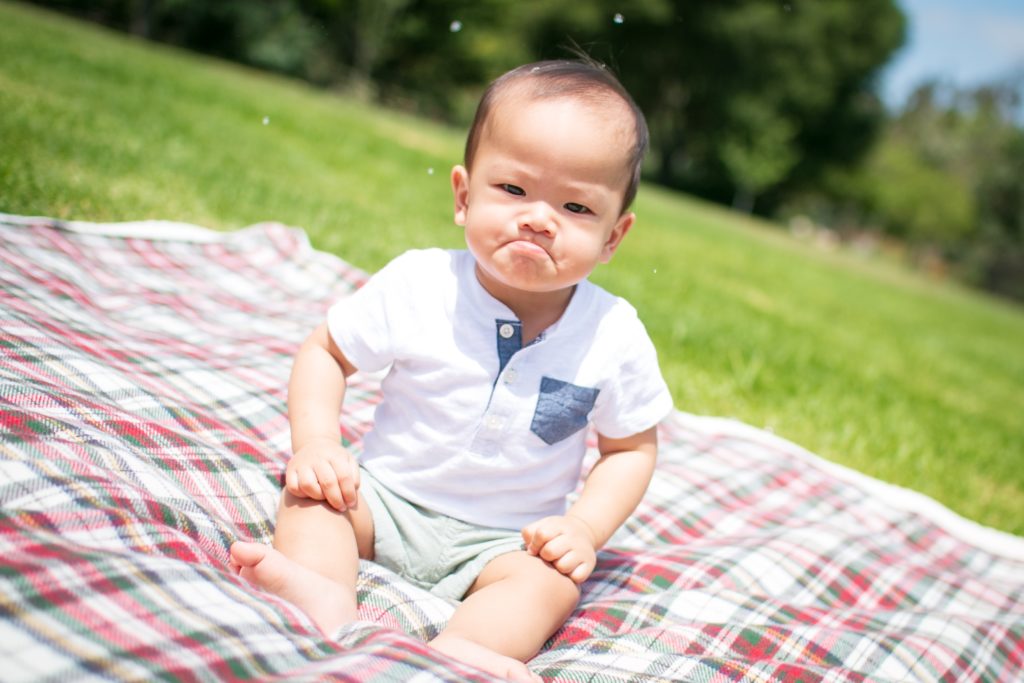 a baby sitting on a blanket