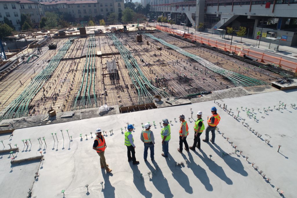 a group of men standing on a roof
