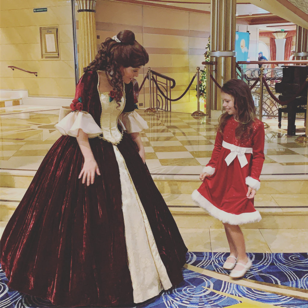 a woman in a red dress and a little girl in a room