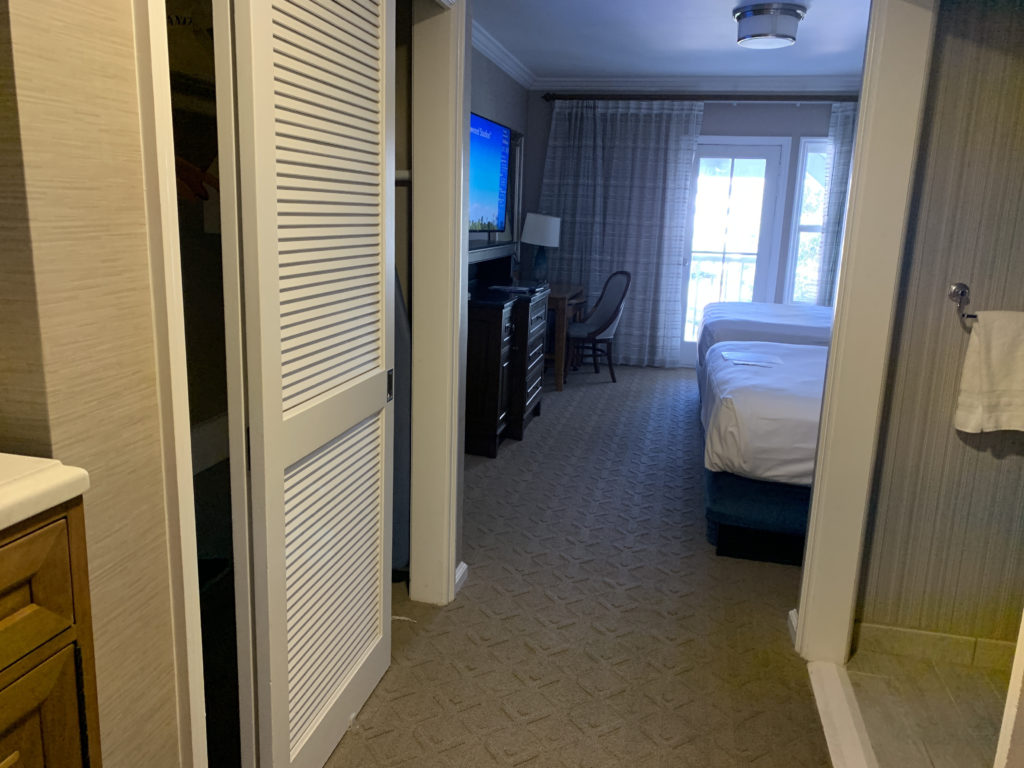 a bedroom with a tv and a dresser