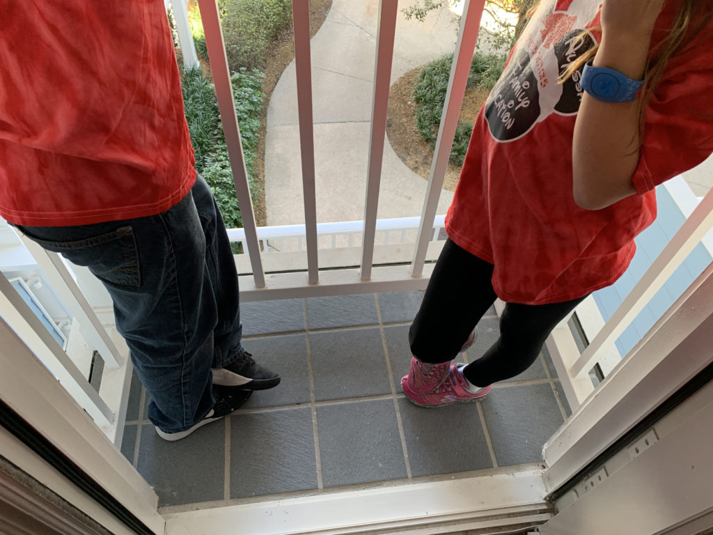 a man and woman standing on a porch