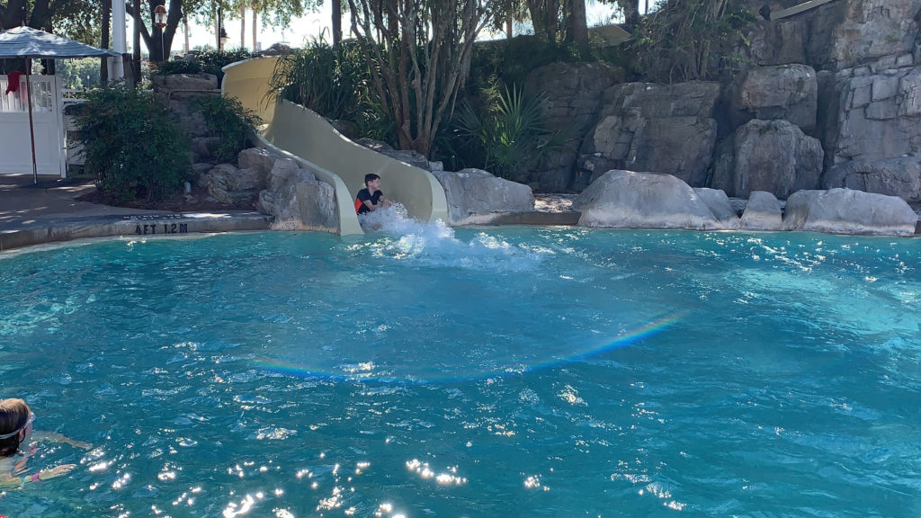 a man on a slide in a pool