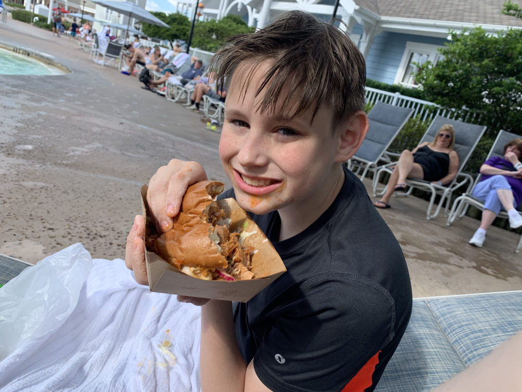 a boy eating a sandwich