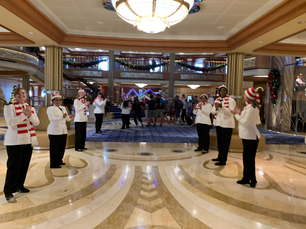 a group of people in a room with a chandelier and lights
