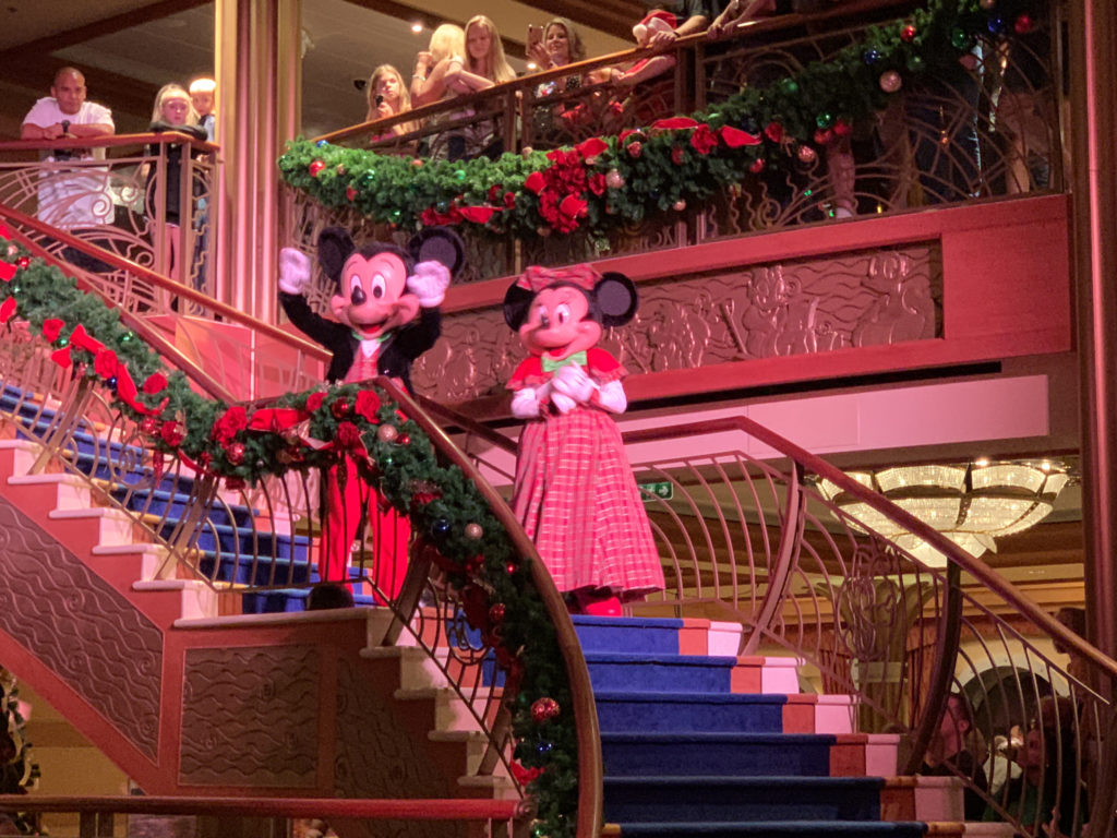 a couple of mickey mouse characters on a staircase