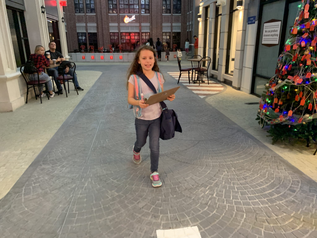 a girl walking on a brick walkway