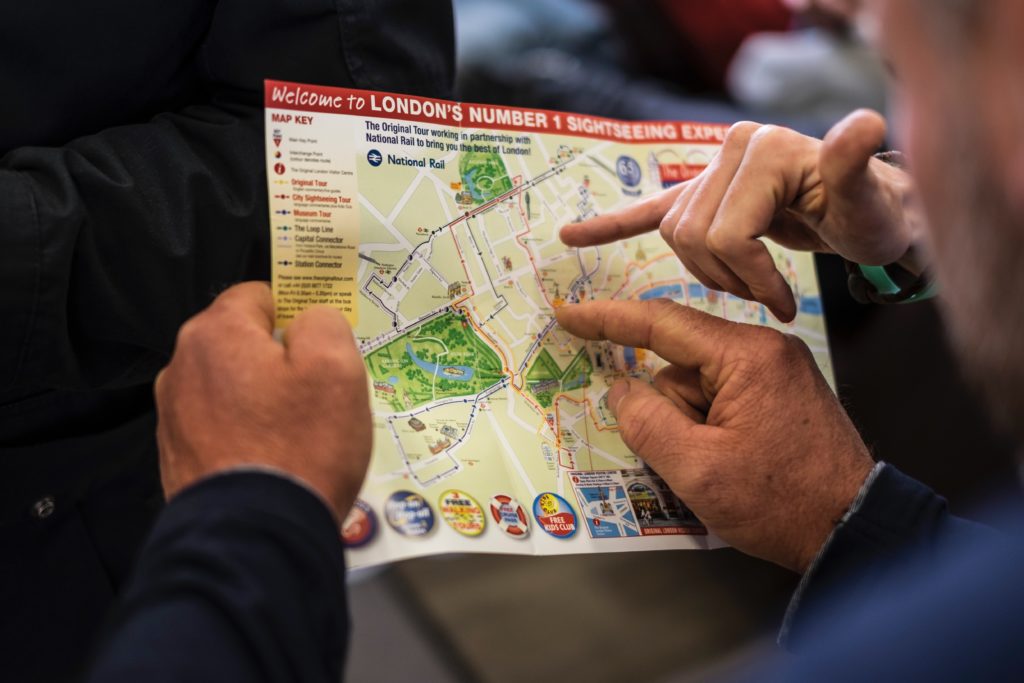 a group of people pointing at a map