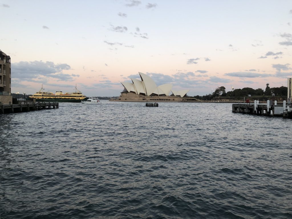 a large building with a boat in the background