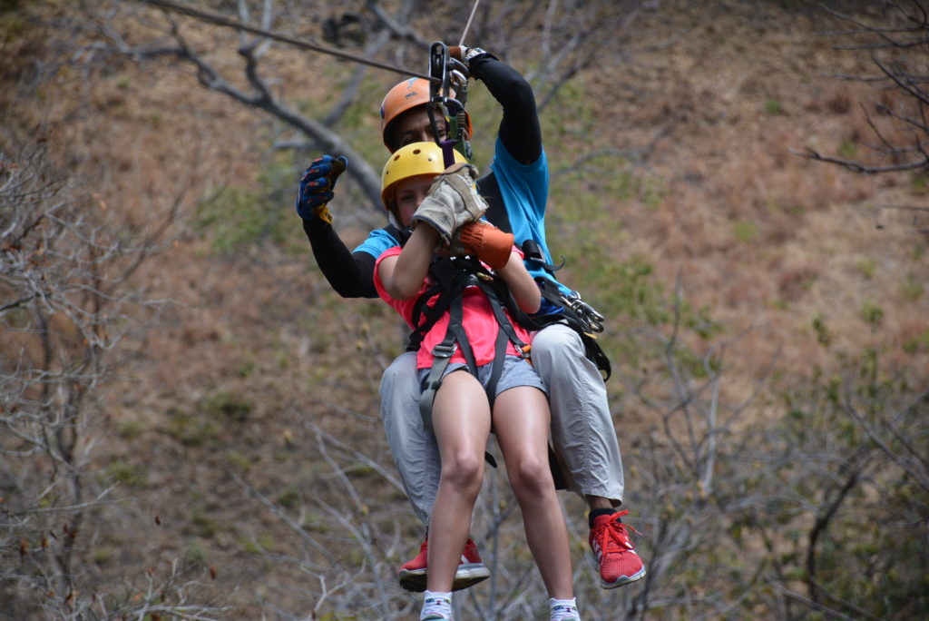 a man and woman in a zip line