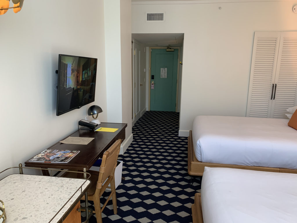 a room with two beds and a tv