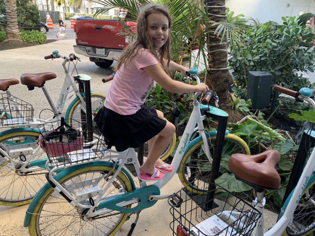 a girl sitting on a bicycle