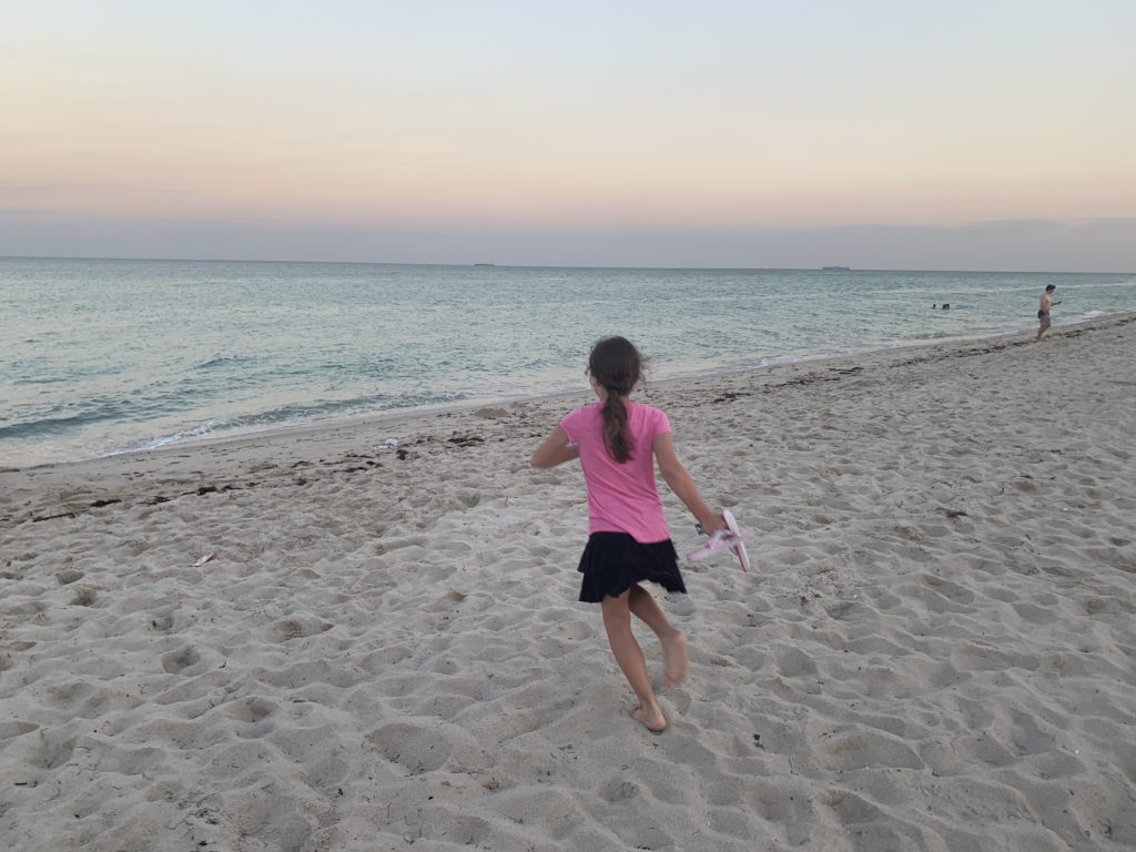 a girl running on a beach