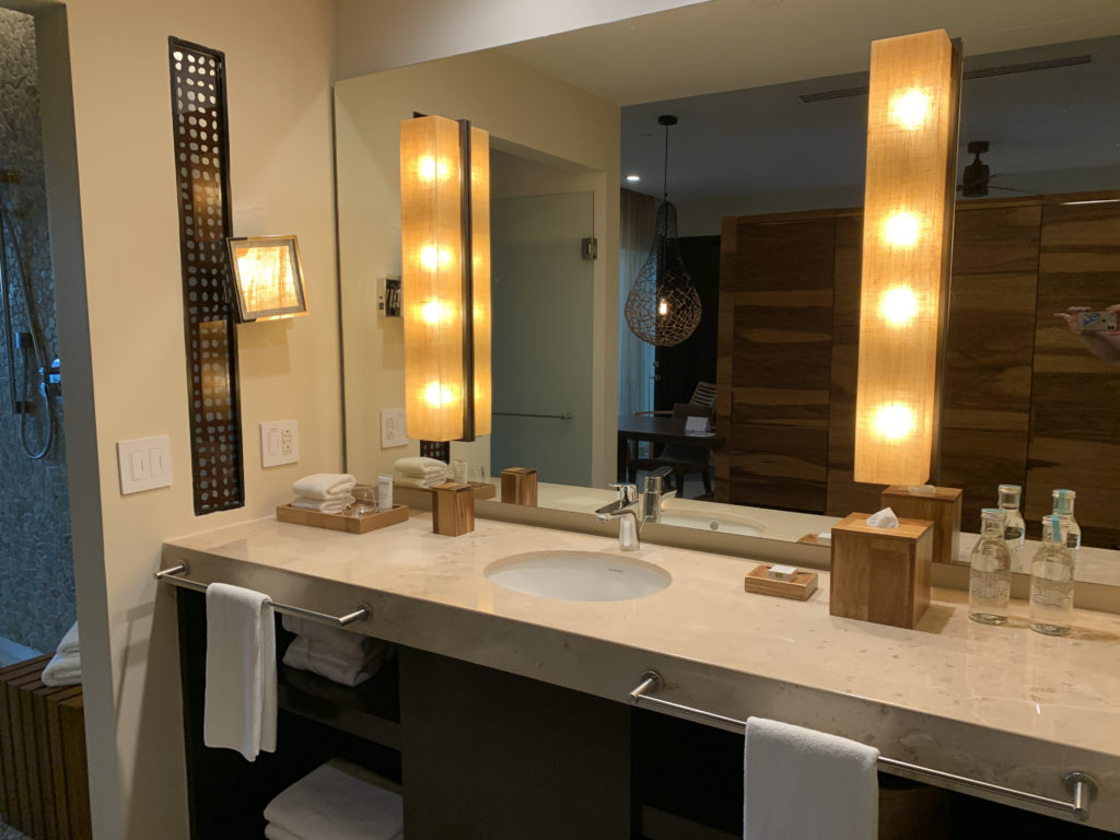 a bathroom with a large mirror and a sink