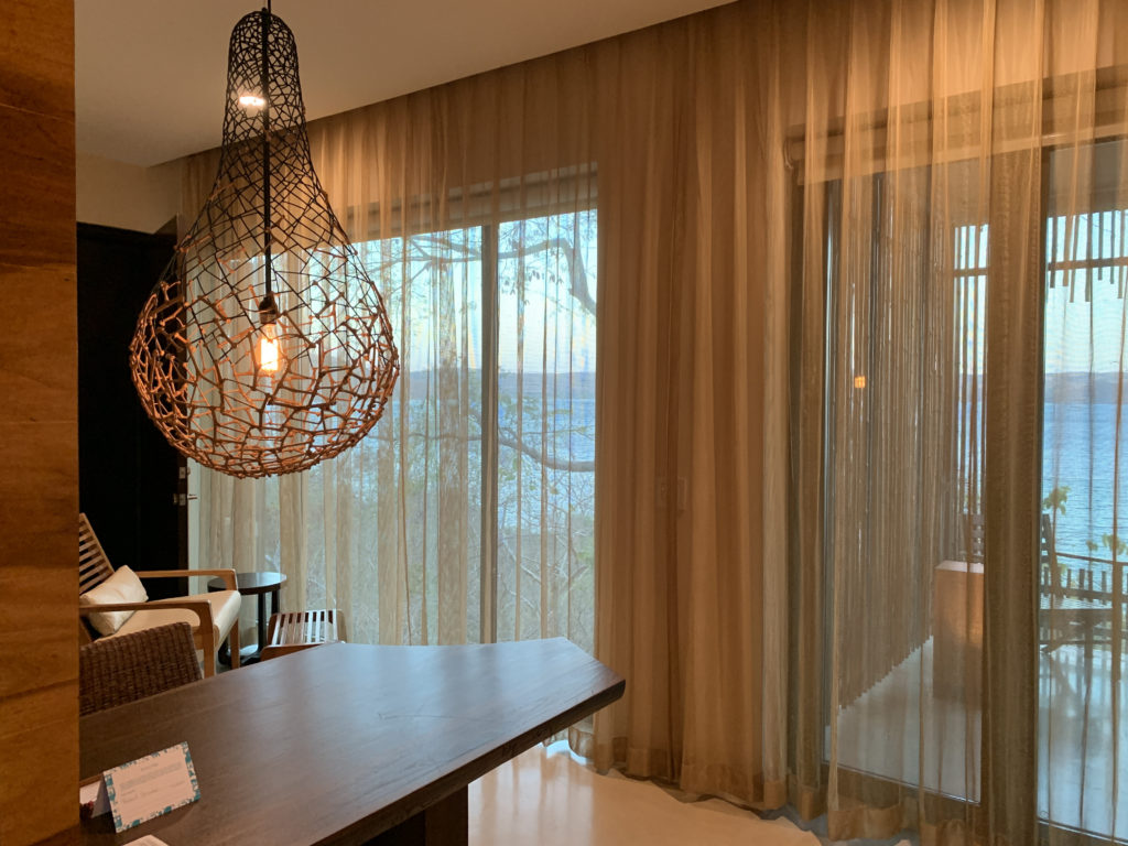 a room with a table and chairs and a chandelier