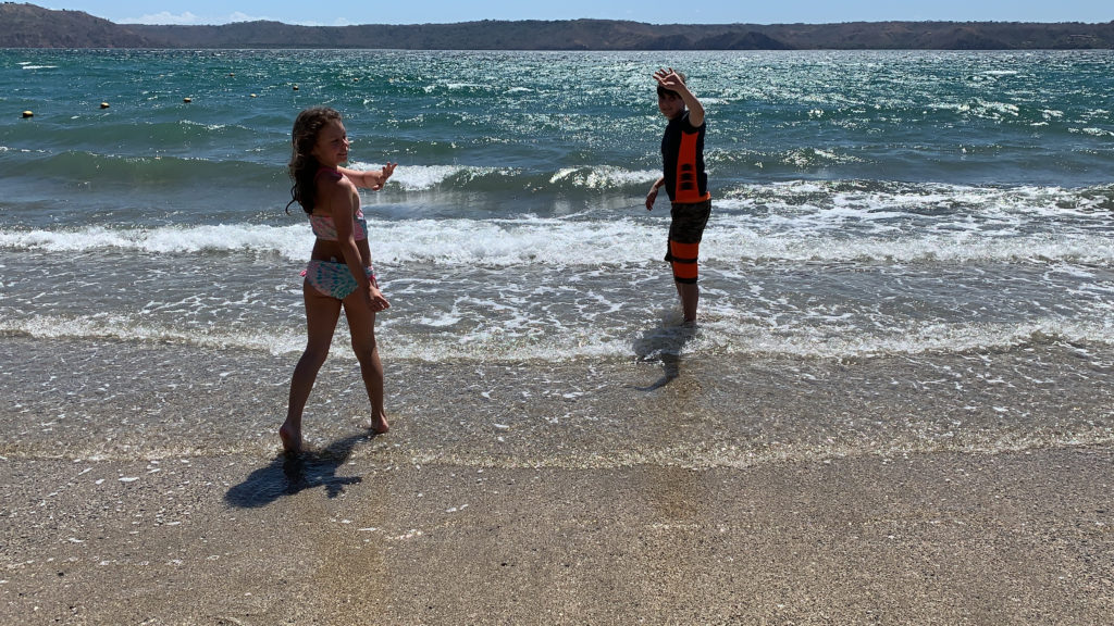 a boy and girl standing in the water