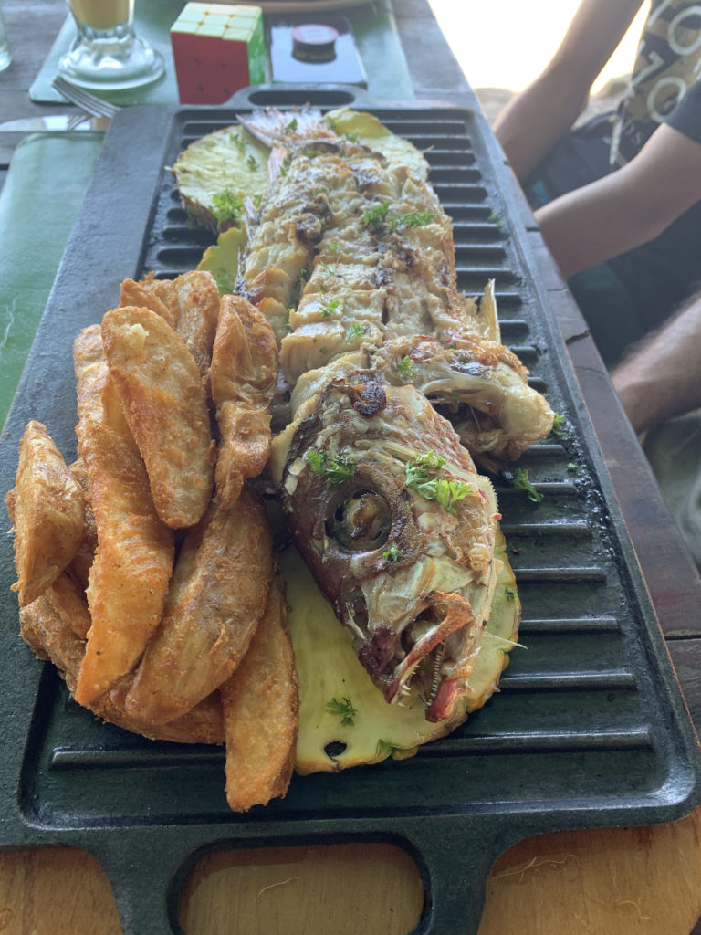 a fish and fries on a grill