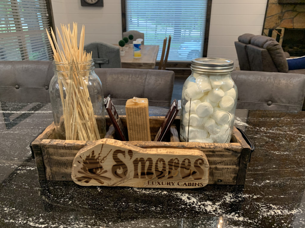 a wooden box with marshmallows and sticks
