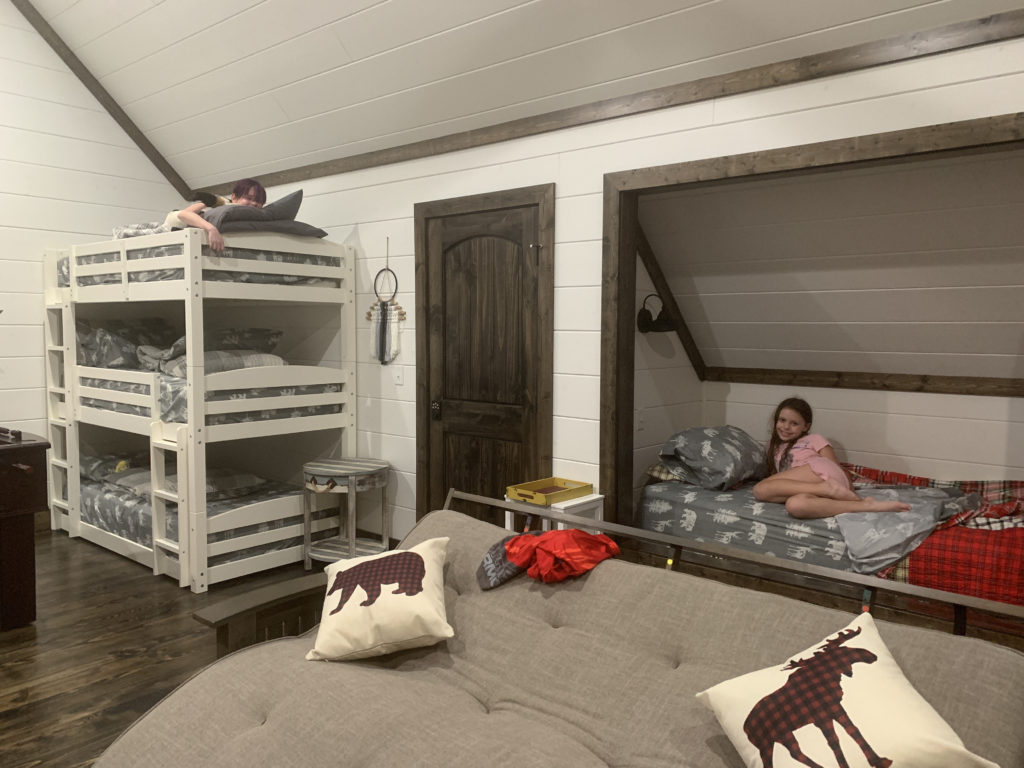 a group of girls lying on bunk beds in a room