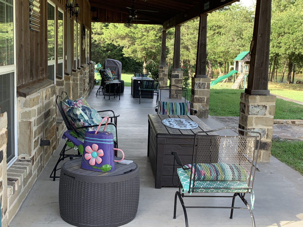a patio with chairs and a table