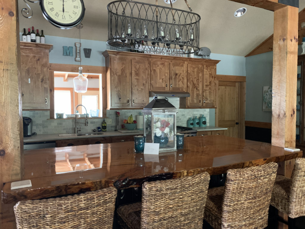 a kitchen with a large table and chairs