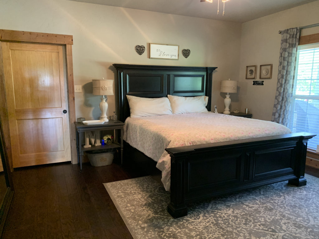 a bedroom with a bed and a rug