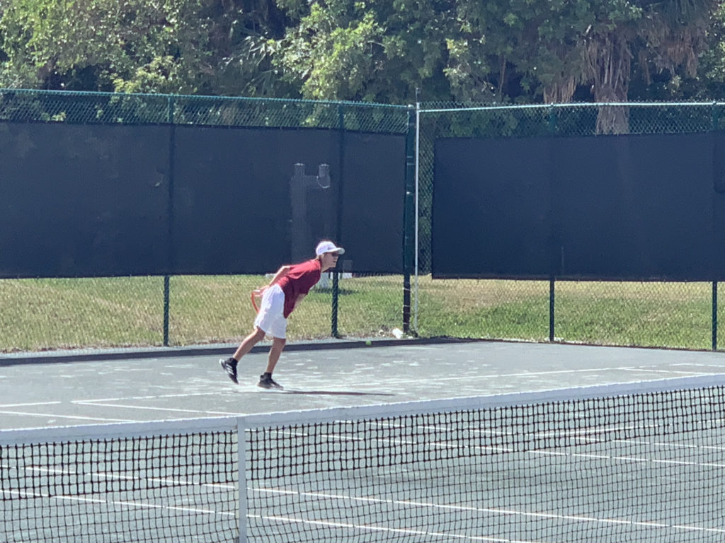 a man playing tennis on a court