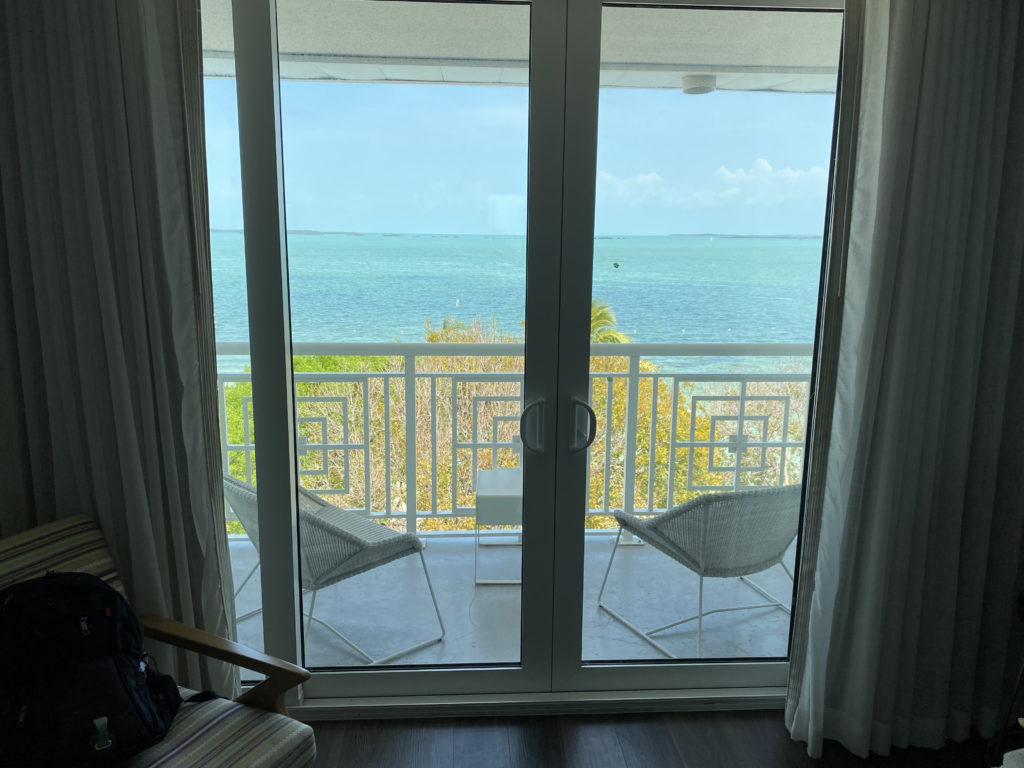 a glass doors with a view of the ocean