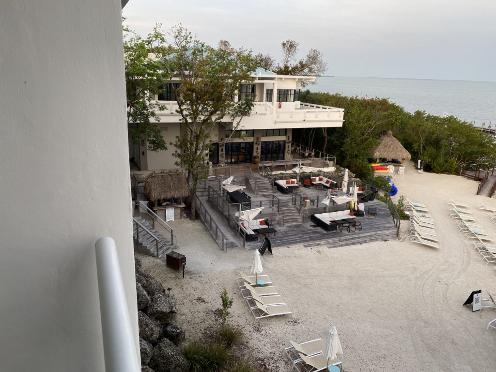 a building with a beach and chairs