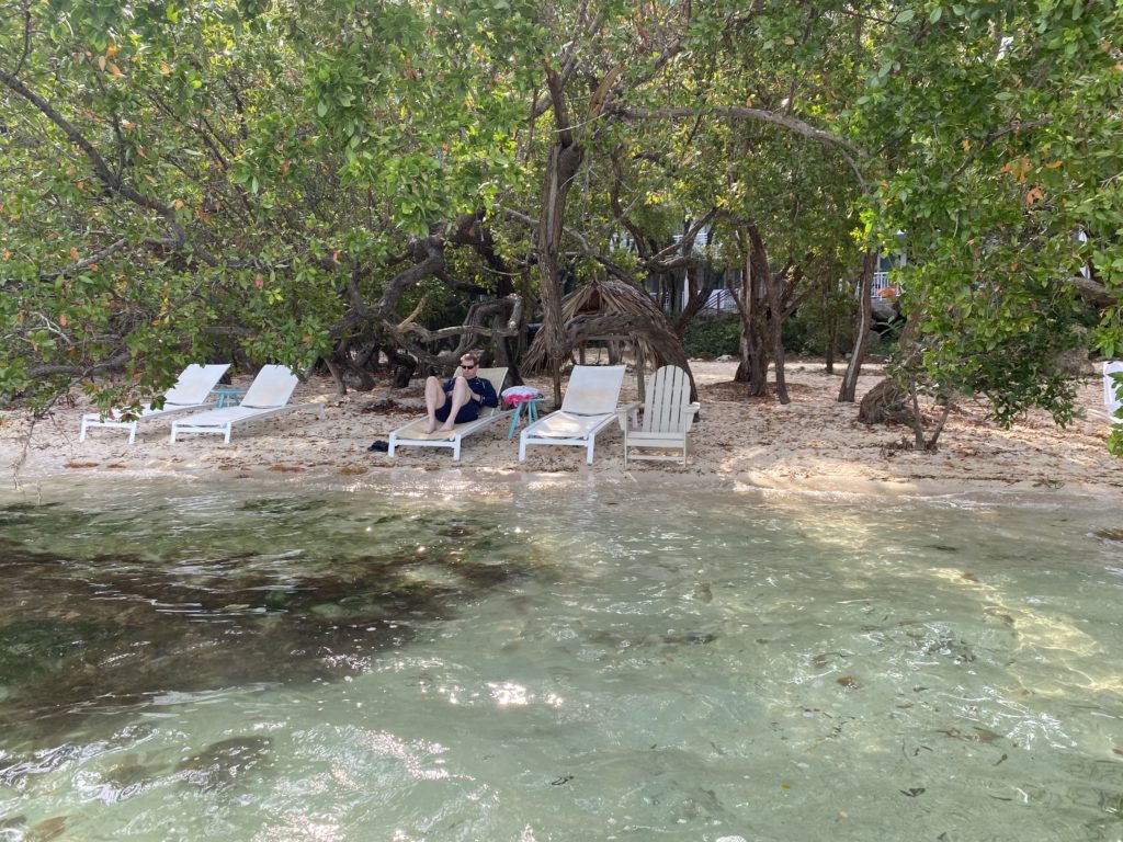 a man sitting on a chair on a beach
