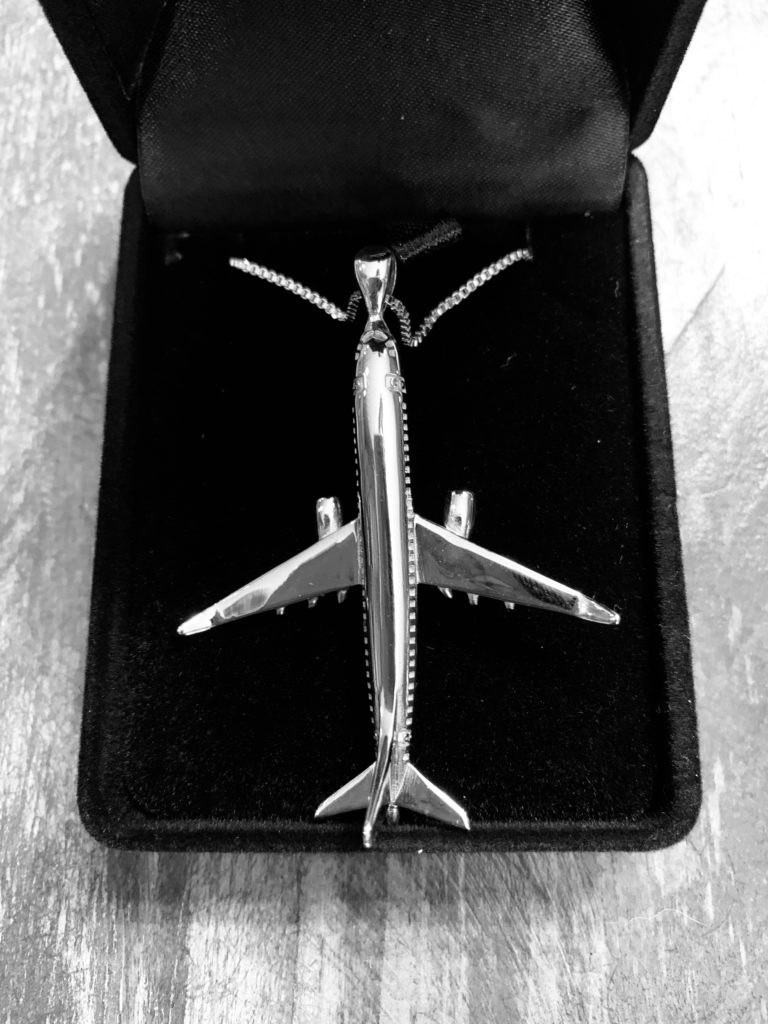 a silver airplane in a box