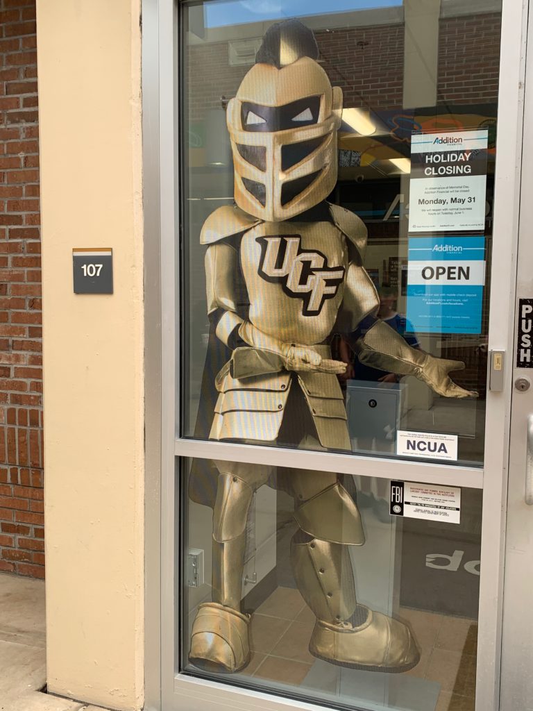 a cardboard cutout of a knight in a glass door