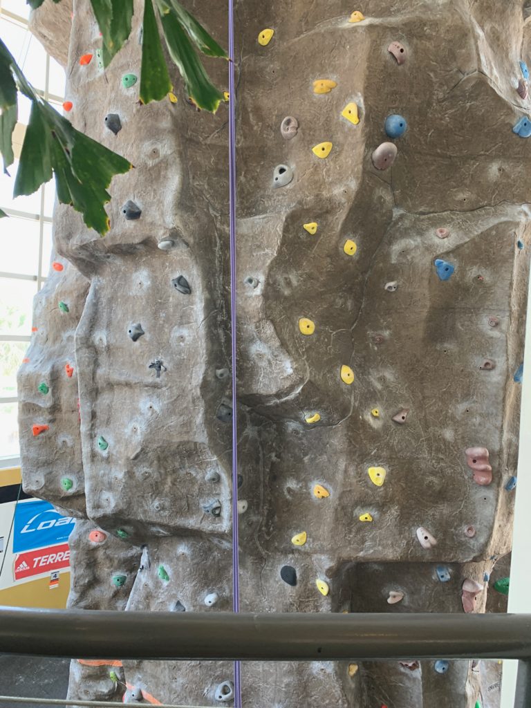 a rock climbing wall with colorful rock climbing