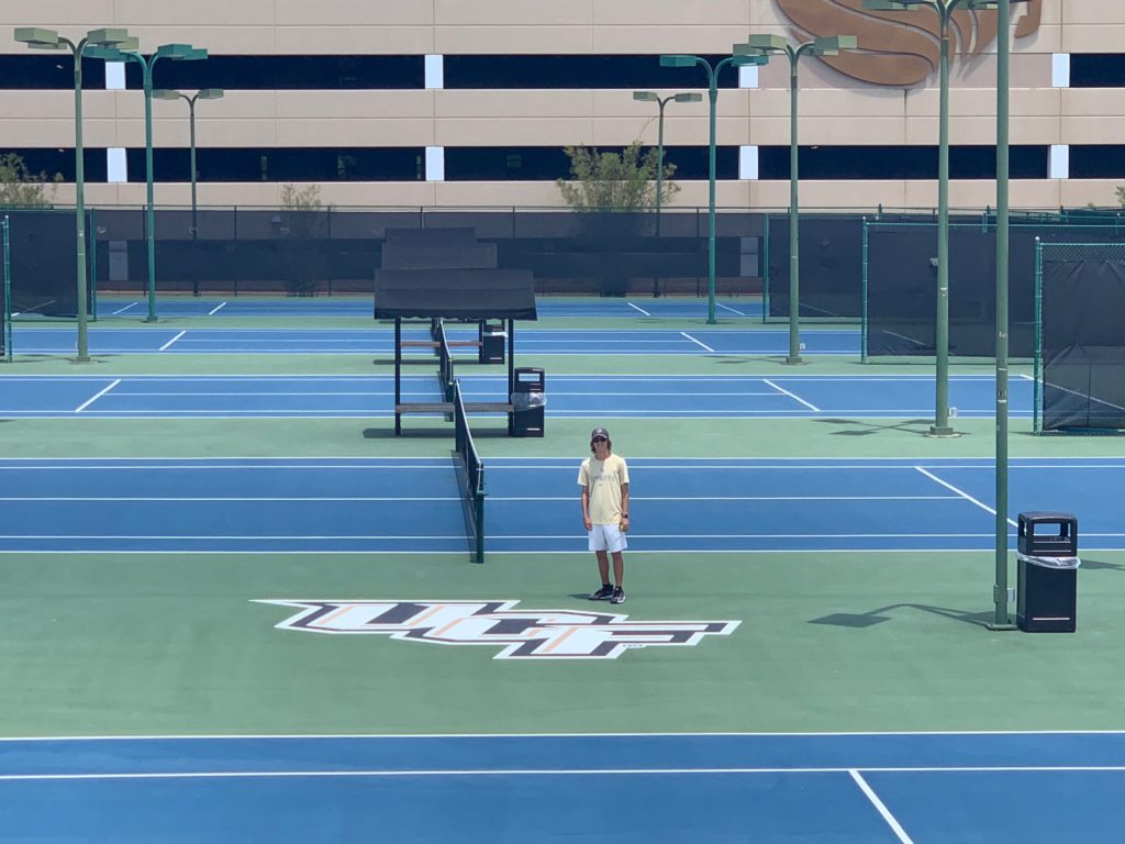 a man standing on a tennis court