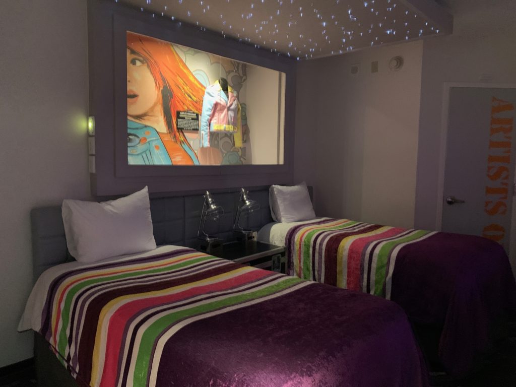 a room with two beds and a television