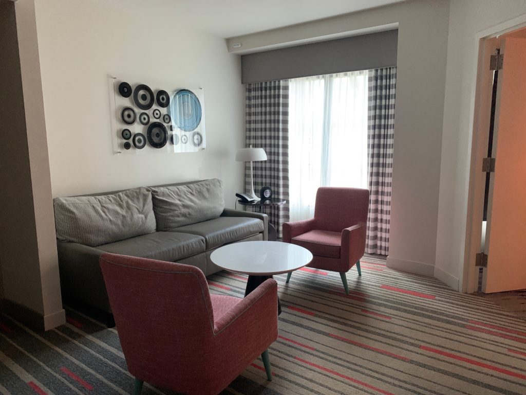 a room with a couch and chairs
