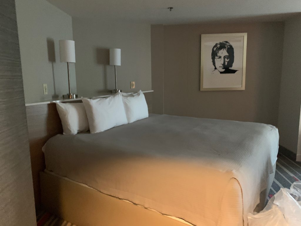 a bed with white pillows and lamps