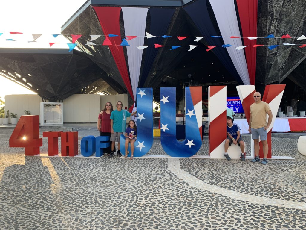a group of people standing in front of a sign
