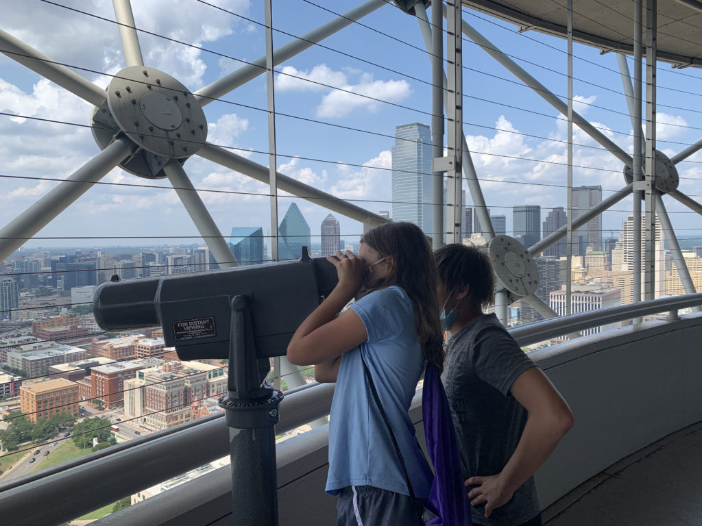 a couple of people looking through a telescope