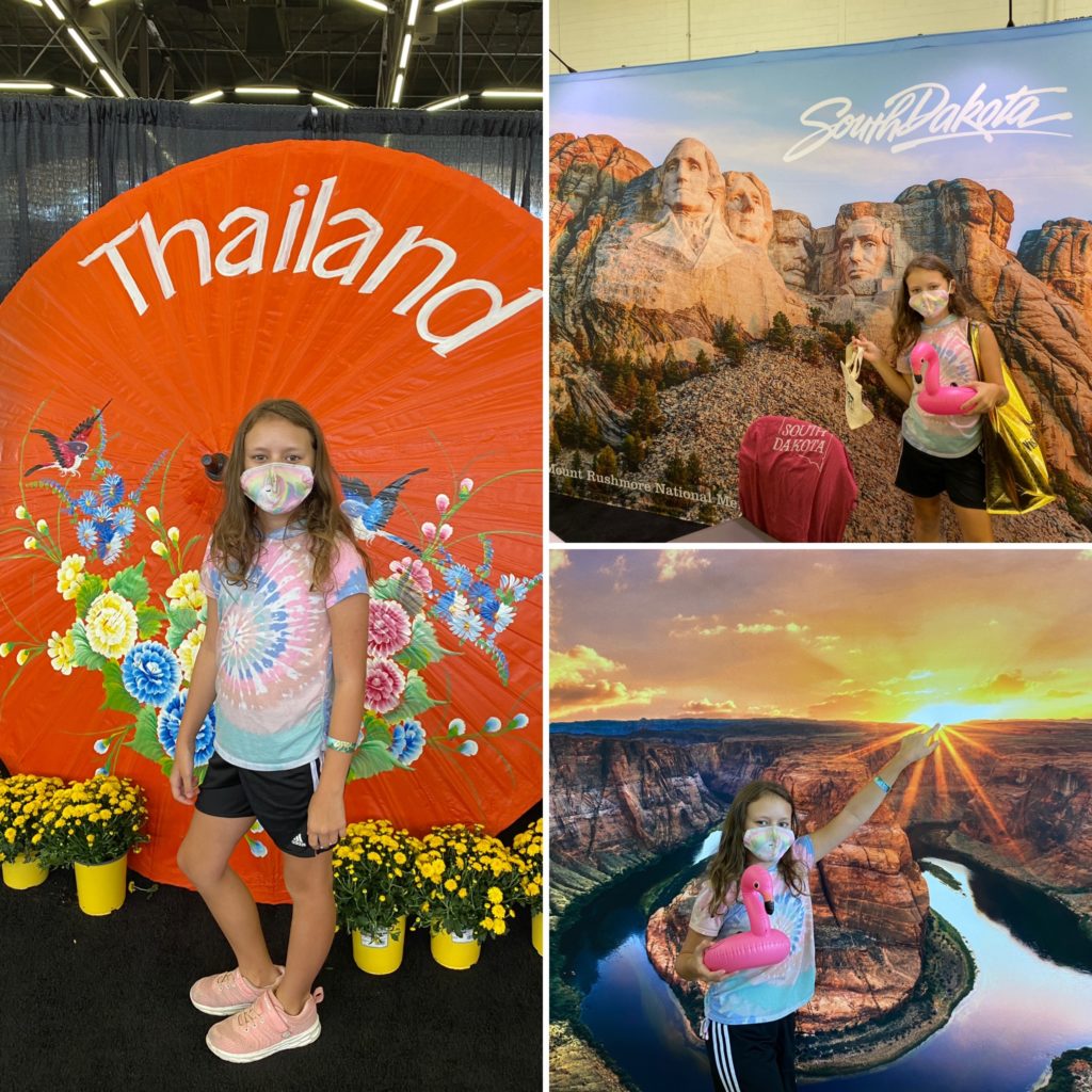 a girl standing in front of a large display
