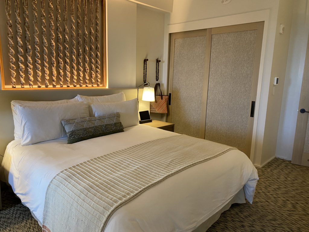 a bed with pillows and a lamp in a room
