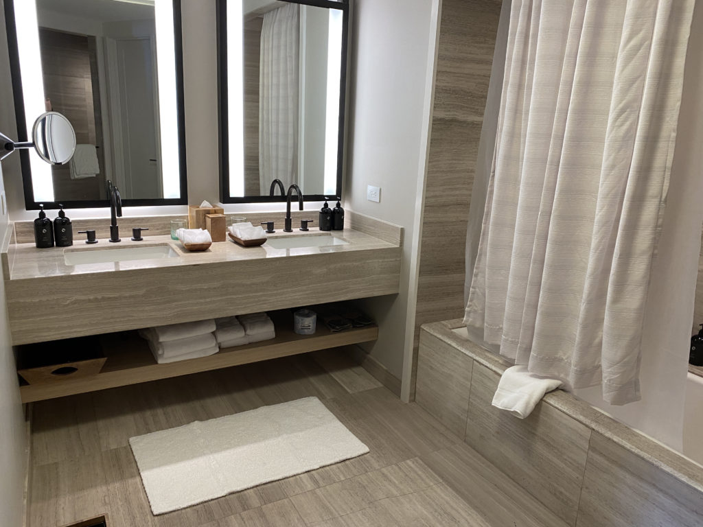 a bathroom with a large mirror and sink
