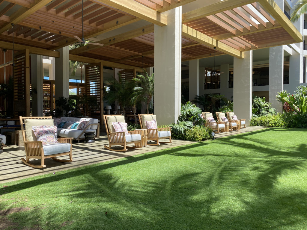 a patio with chairs and a lawn