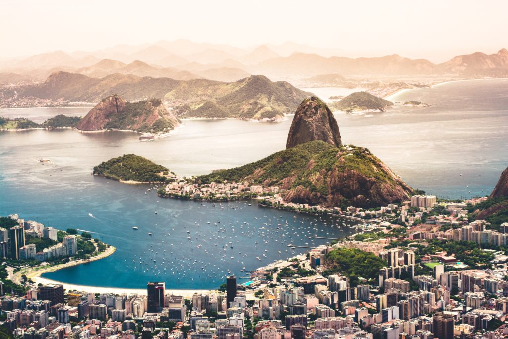 a large city with a body of water and mountains