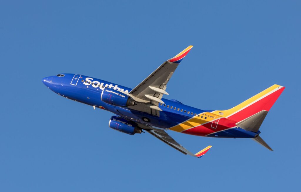 a blue and red airplane in the sky